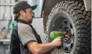 Mechanic Worker doing wheel replacement using impact wrench - 4 Wheel Drive Specialists - Taylored Automotive